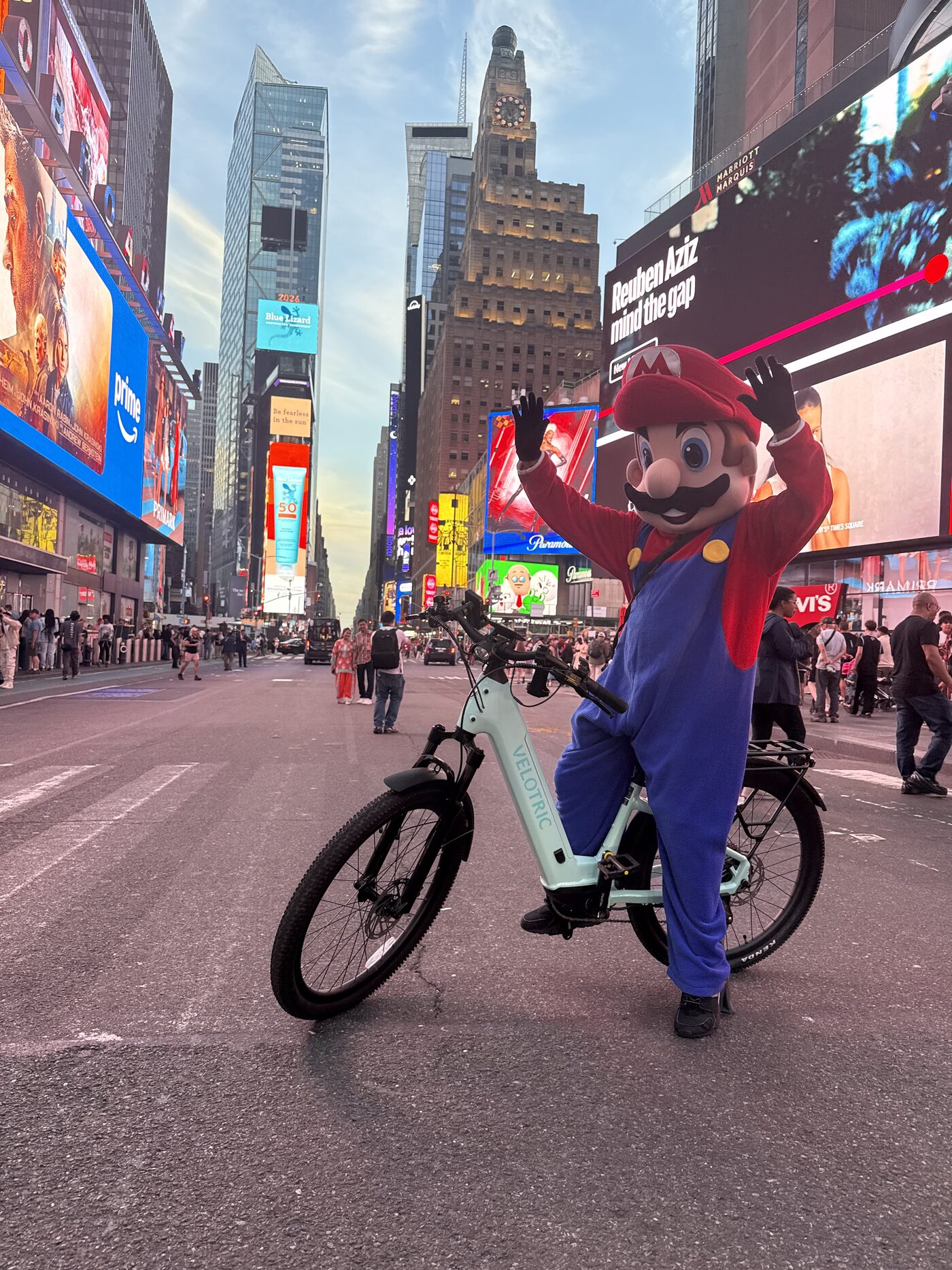 Times Square Broadway billboards with Velotric e-bike rider — bike rental Times Square from Astra Bike Midtown NYC